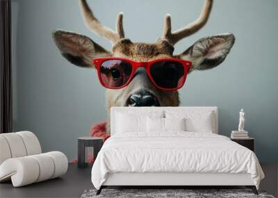 Deer wearing red sunglasses and a cozy sweater against a soft gray background, showcasing a fun and whimsical concept with a playful personality Wall mural