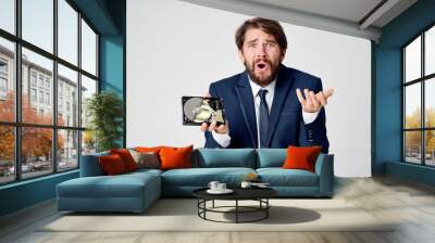 emotional business man in a suit gesturing with his hands and disassembled hard drive Wall mural