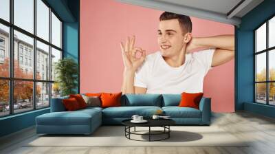 emotional man in white t-shirt gesturing with hands cropped view pink background Wall mural