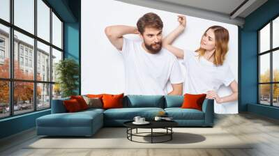 Enamored woman and man t-shirts family friends having fun gesturing with their hands Wall mural