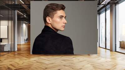 handsome man standing back fashionable hairstyle posing cropped view Wall mural