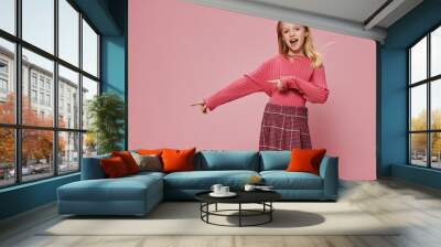 Happy Little Schoolgirl with Stylish Pink Outfit and a Joyful Smile, Surrounded by a Vibrant Studio Background Wall mural