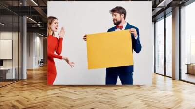 Happy woman and man with yellow sheet of paper on Light background Poster mockup Wall mural