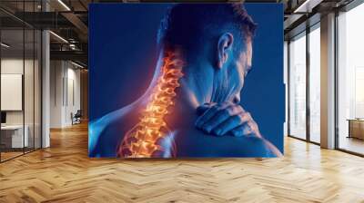 Human spine anatomy, back pain relief, wellness concept featuring a male figure with illuminated spine against a blue background emphasizing health and fitness Wall mural