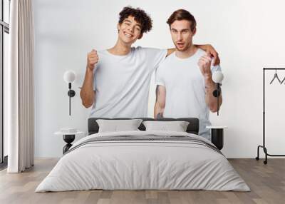 male friends in white t-shirts on an isolated logo background Wall mural