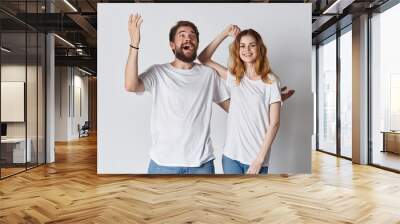 man and woman with hands up Wall mural