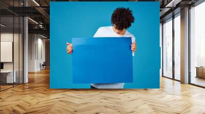 man holding a blank board Wall mural