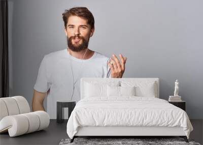 man in white t-shirt with beard lifestyle casual wear Studio light background Wall mural