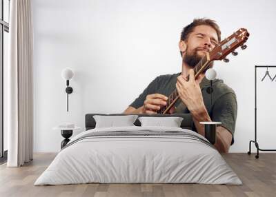 man plays the guitar and enjoys it Wall mural