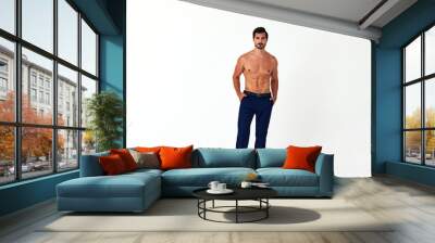 Man with bare torso and prue cubes in business pants shows full-length nude body, women's day March 8 on white isolated background copy space  Wall mural