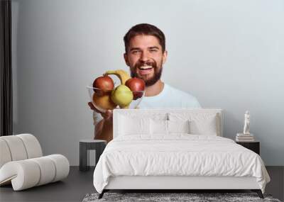 man with fresh fruit in a glass cup gesturing with hands vitamins health energy model bushy beard mustache Wall mural