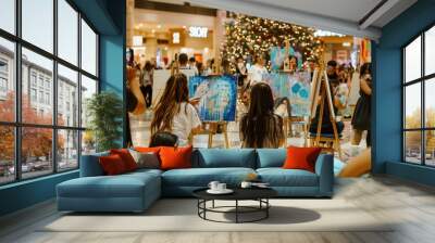 People in the mall painting together with christmas tree in background during art workshop Wall mural