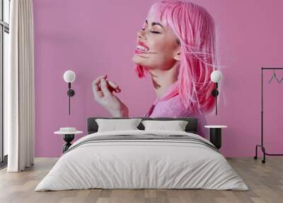 Portrait of a charming lady modern style pink hair Red lips fashion pink background unaltered Wall mural