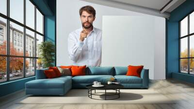 portrait of a young man holding blank board Wall mural