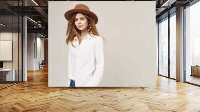 Pretty woman in hat white shirt elegant style fashion light background Wall mural