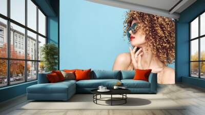 Pretty woman With curly hair holds a hand near the face of red lips fashion style  Wall mural