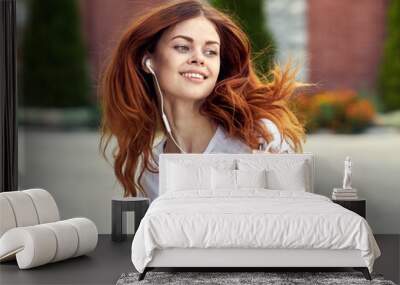 redhead woman outdoors walk headphones fun music Wall mural