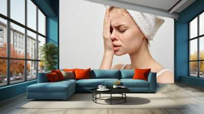 sad woman with a towel on her head on face acne skin problem Wall mural