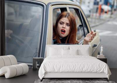 strict woman driving a car, emotions, stress Wall mural