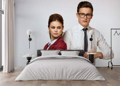 Work colleagues Business couple office officials team studio light background Wall mural