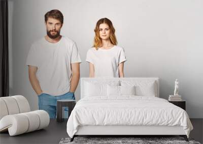 young couple in white shirts logo woman man Wall mural