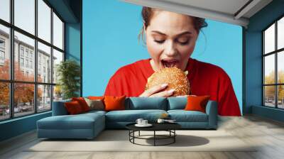 young girl eating a sandwich Wall mural