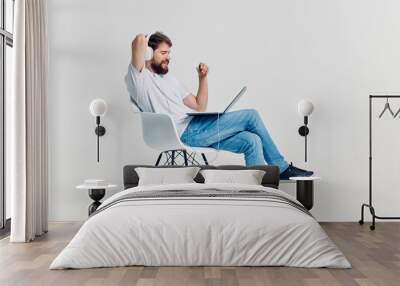 young man sitting on a chair Wall mural