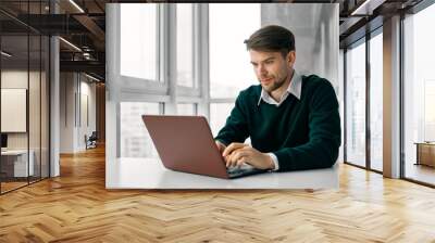 young man working on laptop at home Wall mural