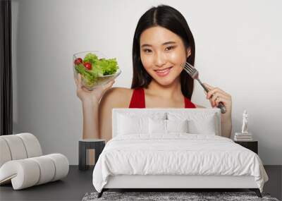 young woman eating salad Wall mural