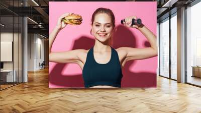 young woman exercising with dumbbells Wall mural