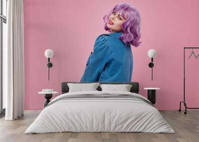 Young woman wavy purple hair blue jacket emotions fun color background unaltered Wall mural