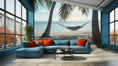 Empty hammock hanging between two palm trees on a tropical beach with turquoise water Wall mural