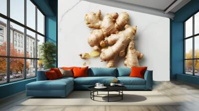 Fresh ginger root on white marble countertop, perfect for cooking. Organic, healthy, aromatic spice for vegetarian, vegan, or wellness. Close-up, top view with copy space Wall mural