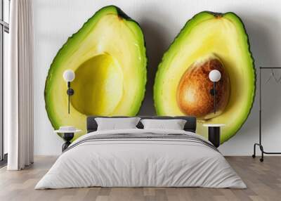 Two halves of fresh avocado lying on a white background, showcasing their vibrant green flesh and large brown seed Wall mural