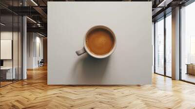 White coffee mug with foamy milk sitting on a white tabletop Wall mural