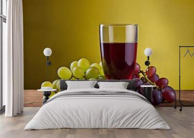 A glass of grape juice or wine and a bunch of grapes Wall mural