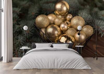 Stylish box of Christmas Golden toys on a wooden background and branches of Christmas trees Wall mural