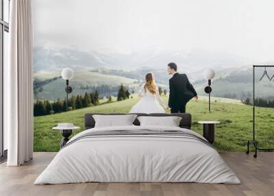 beautiful bride and groom at the mountains Wall mural