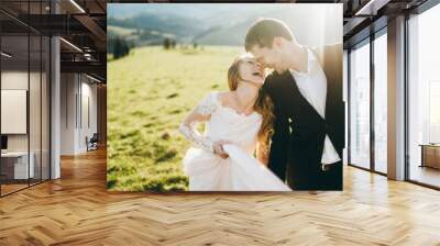 Beautiful bride and groom at the mountains Wall mural