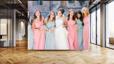 Beautiful bride with her pretty bridesmaids Wall mural