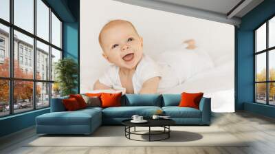 Portrait of adorable baby girl laying on comfortable bed at home, cute little kid enjoy happy childhood, beautiful toddler smiling, childcare concept Wall mural