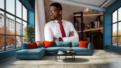 Portrait of handsome african business man with red tie and black glasses in the office Wall mural