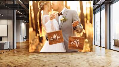 Wonderful wedding couple in the forest at sunset. Mister and Missis. Wall mural