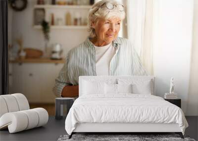 coziness, domesticity and leisure concept. portrait of stylish gray haired woman with round spectacl Wall mural