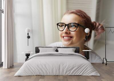 Headshot of adorable cute young Caucasian female in big eyewear and choker necklace smiling broadly, showing her perfect straight teeth, feeling happy and excited while making plans for weekend Wall mural