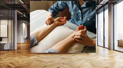 Healthy lifestyle, wellness and manual therapy concept. Cropped shot of therapist hands checking health condition, measuring pulse rate on female patient wrists before acupuncture treatment Wall mural