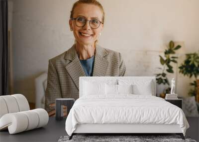 horizontal portrait of mature caucasian stylish good-looking woman real-estate agent showing house,  Wall mural