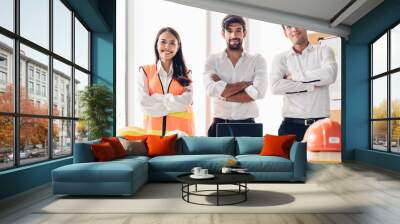 Group of engineer young asian and caucasian standing and cross arms after meeting. Teamwork people engineer consultant entrepreneur casual brainstorm. Industry, Engineer and construction concept. Wall mural