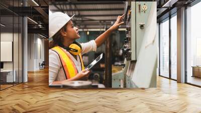 Industrial factory maintenance engineers woman inspect relay protection system of machinery and holding digital tablet with copy space. Industry, Maintenance, Engineering and construction concept. Wall mural