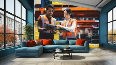 Warehouse worker and manager checks stock and inventory with using digital tablet computer in the retail warehouse full of shelves with goods. Working in logistics, Distribution center. Wall mural